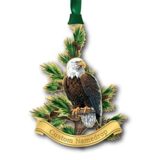 A gold Christmas ornament hanging from a green cord featuring Bald Eagle perched on a branch with a custom namedrop banner.
