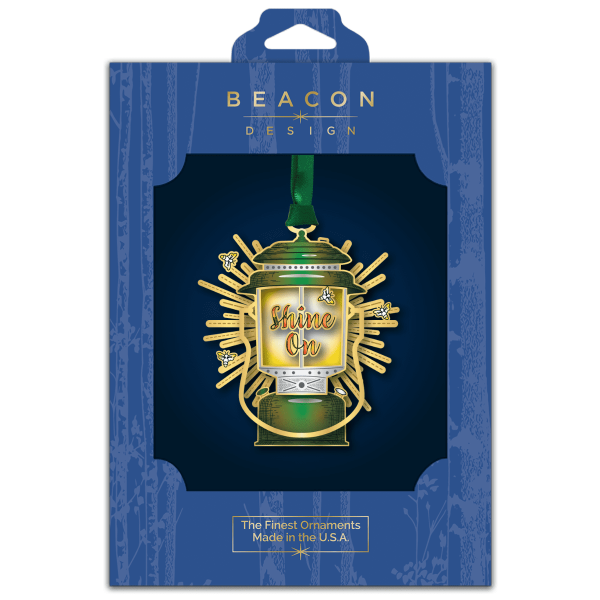 Custom ornament featuring a vintage lantern surrounded by bees and sunburst accents with the phrase “Shine On,” displayed in Beacon Design retail packaging