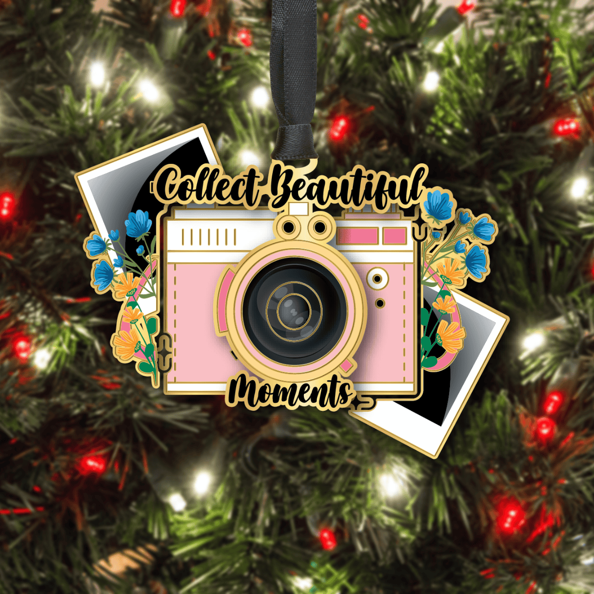 Custom ornament featuring a vintage camera surrounded by flowers and photo prints with the phrase “Collect Beautiful Moments,” displayed on a decorated Christmas tree
