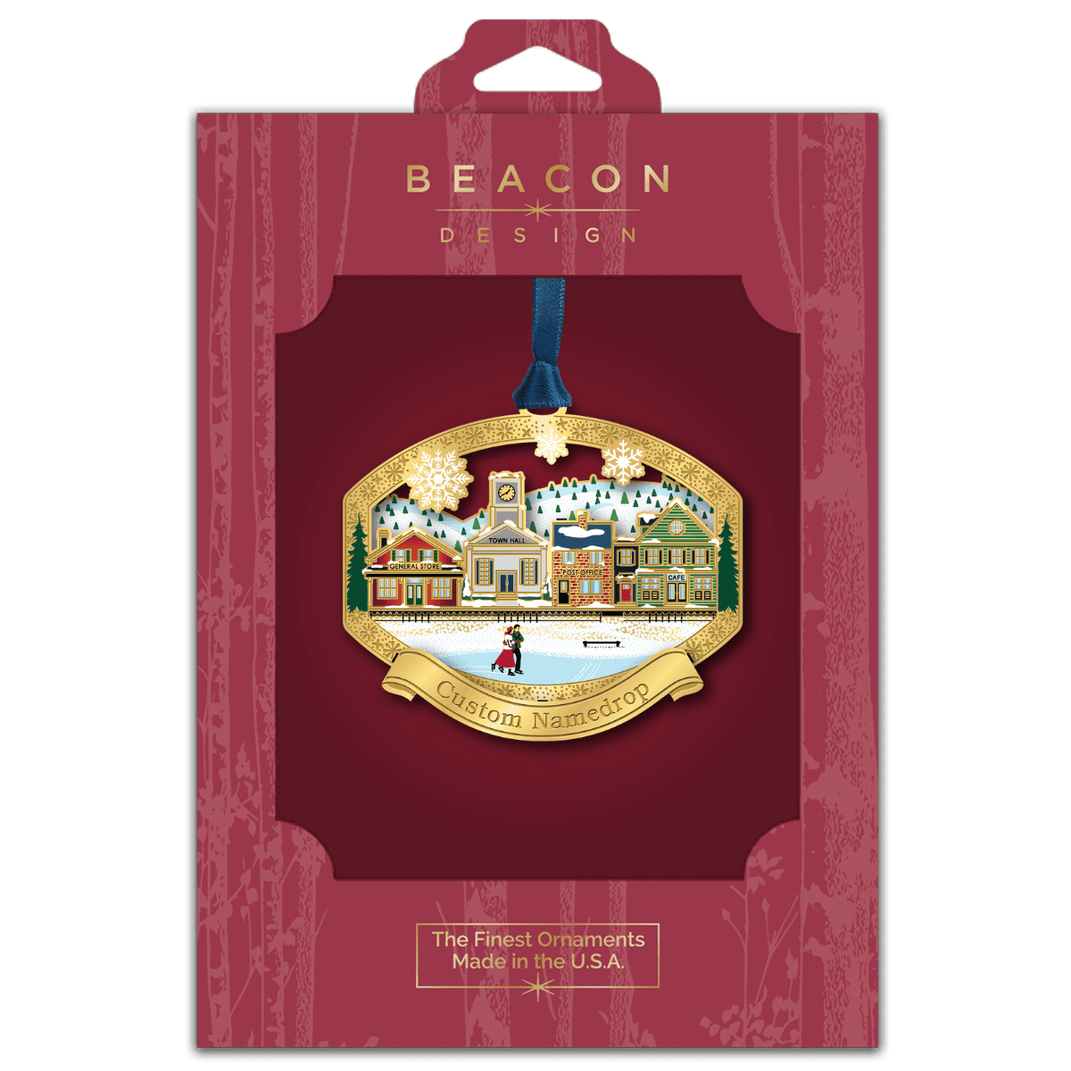 Custom namedrop ornament featuring a winter village with a general store, town hall, post office, and café, displayed in Beacon Design retail packaging