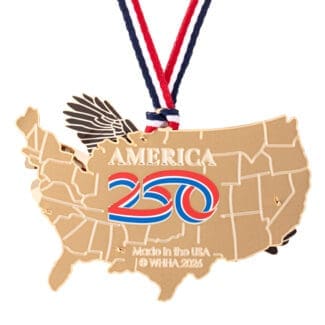 Close-up of the back of an America250 commemorative ornament shaped like the United States, featuring gold plating, a tricolor “250” emblem, engraved “Made in the USA”.