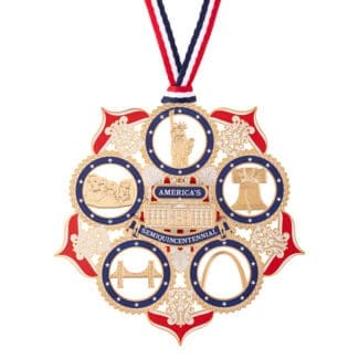 Full view of the America250 American Icons commemorative ornament hanging from a red, white, and blue ribbon, featuring gold plating and circular frames with iconic U.S. symbols.